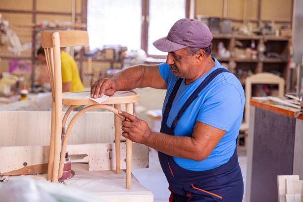 istock Indian carpenter making a wooden chair 1413273231