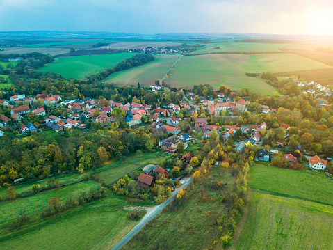 Stunning aerial shot of Subotica, a charming city in the Vojvodina region of Serbia, showcasing its suburban neighborhoods, lush green fields, and the urban horizon beyond.