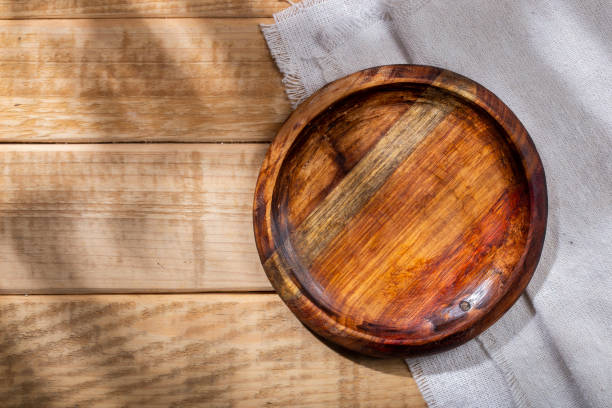 istock Circular shaped wooden bowl on the table, top view 1413283904
