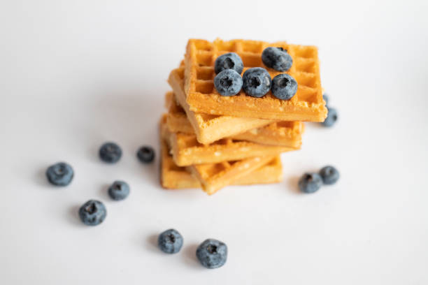 istock sweet dish Belgian waffles with blueberries on a white background 1413284896