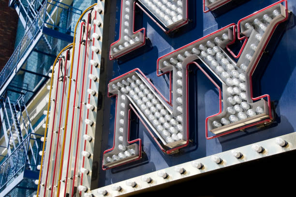 New York sign in lights New York sign in lights with stairs on the side of building in background manhattan theater district stock pictures, royalty-free photos & images