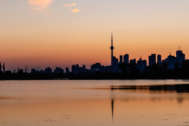 Toronto, Canada - View of the urban skyline from Polson Pier as sun sets behind city.