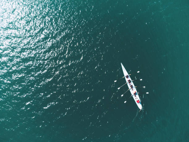 foto aérea de quatro pessoas remando no mar. - oar rowing sport rowing team - fotografias e filmes do acervo