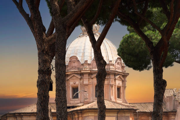 Historical and artistic dome structure in Rome, Italy, seen through the Umbrella Pine Trees.
