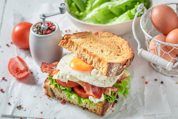 istock Fresh and healthy toasted sandwich with egg, bacon and vegetables. 1413295989