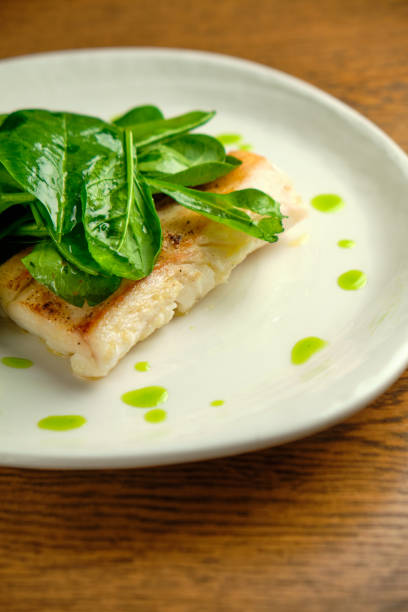istock Pike perch fish fillet with spinach leaves 1413300573