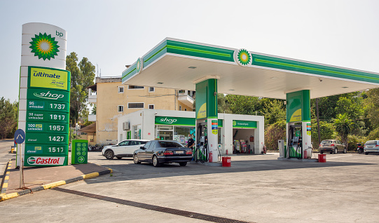 Corfu, Greece - August 03, 2021: Driver refuel cars at BP gas station. British Petroleum Company is an oil and gas company headquartered in London, England.