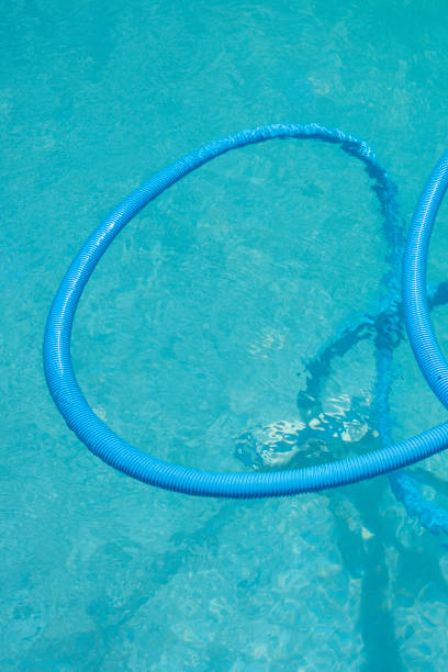istock vacuum cleaning hose for a swimming pool, summer time concept 1413303159