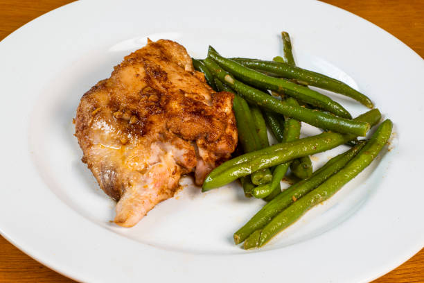istock baked chicken thigh served with sauteed  green beans 1413304382