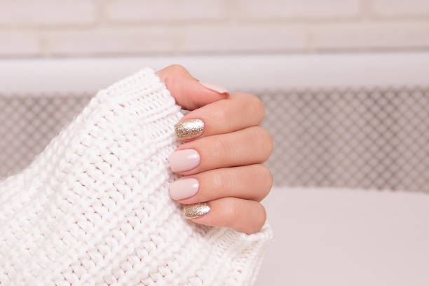 istock Female hands with beige manicure nails 1413305350
