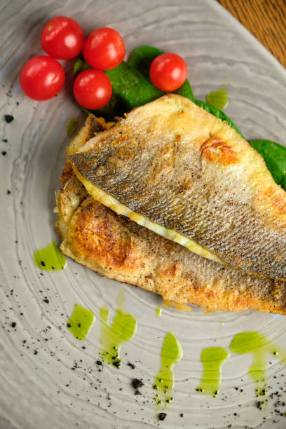 istock Fried fish fillet with tomatoes 1413306651