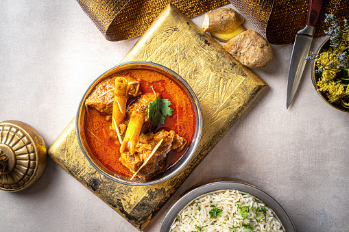 indian spices Nalli ihari Rogan josh with rice and ginger served in a dish isolated on dark background top view food