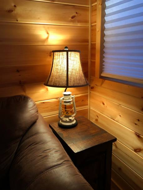 istock Artistic lampshade by a brown sofa in a wooden cabin 1413315541