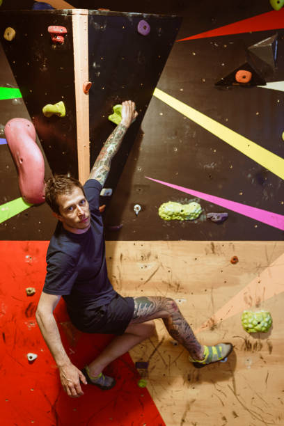istock Man at an Indoor rock climbing gym 1413315599