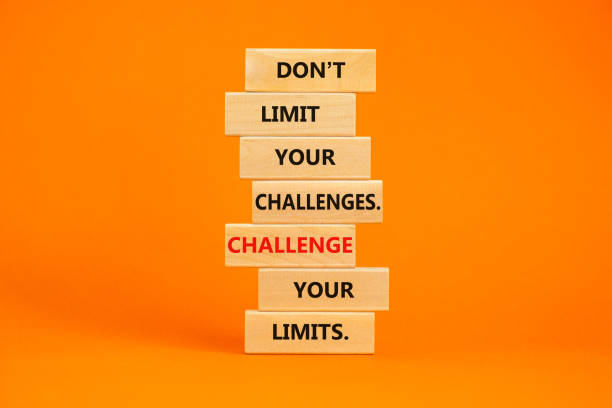istock Do not limit your challenges symbol. Wooden blocks with words Do not limit your challenges. Challenge your limits. Beautiful orange background, copy space. Business concept. 1413319081