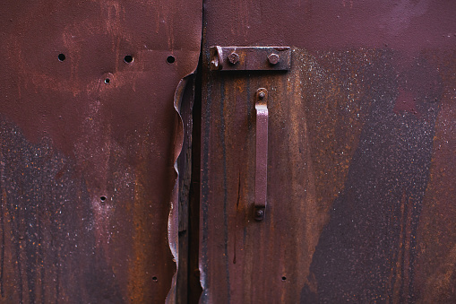 Old metal door with lock. Freedom concept. Industrial background. Grunge
