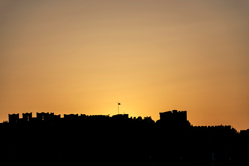 Silhouette view of the ramparts around the old town of Rhodes at sunset and backlight in Greece.