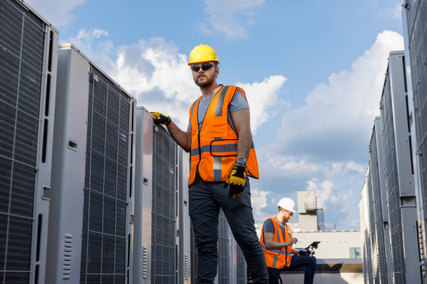 istock Aircondition units repair on a rooftop. Supervisor and worker checking air condition system and logging results with a portable computer. 1413326499