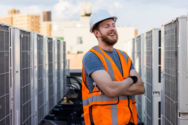 istock Mechanic technician posing near rooftop air conditioning units. 1413326516