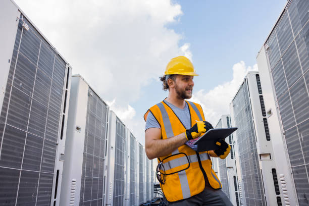 istock Blue collar worker checking air condition system and logging results with a portable computer. 1413326519
