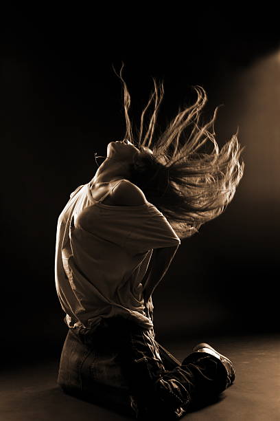 istock cool woman dancer against black background 141332702