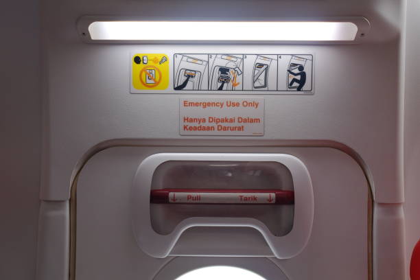 an emergency door in the aircraft cabin - vehicle door imagens e fotografias de stock