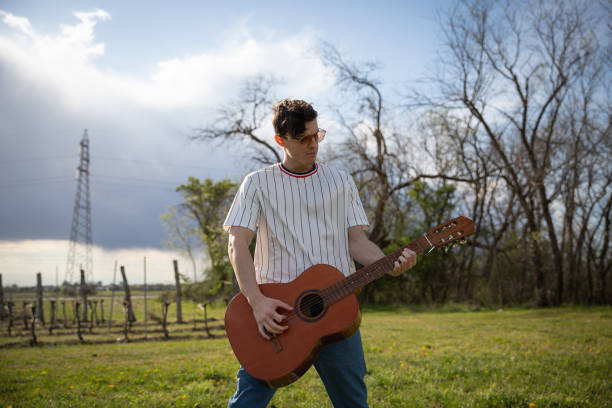istock a musician plays classical guitar when outside in the fresh air. 1413329102