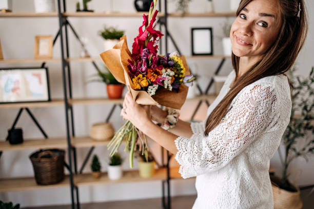 istock Beautiful woman with a flower in her hands 1413329105