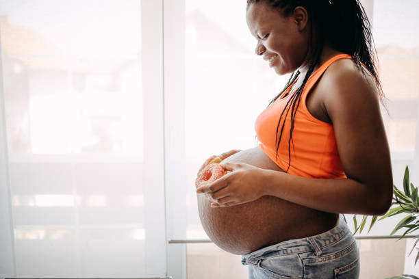 istock Pregnant woman and donuts 1413331697