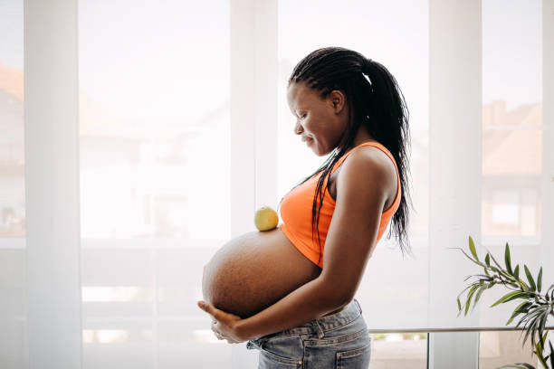 istock Pregnant woman holds her belly 1413331825