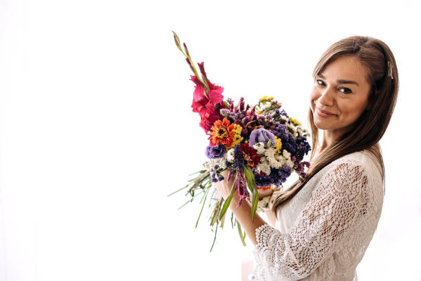 istock Beautiful woman with a flower in her hands 1413331870