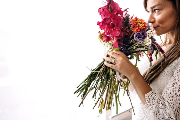 istock Beautiful woman with a flower in her hands 1413331879