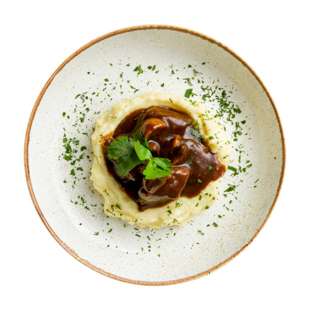 istock Beef cheeks with mashed potatoes and demiglass sauce isolated on white background top view 1413334680