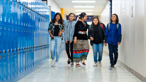 istock High school kids walking on a corridor alongside the lockers 1413335472