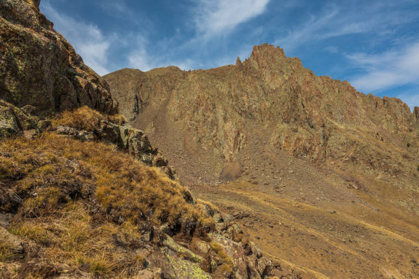 istock Golden mountain tundra with rock cliffs 1413348393
