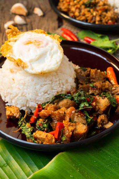 istock Stir fried Thai basil with minced pork,criscy pork,and a fried egg Topped on Rice 1413353374