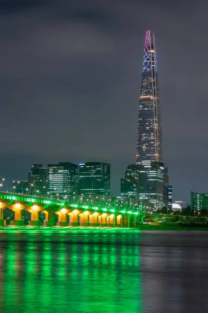 Night view of Jamsil bridge, Lotte World Tower skyscraper and Han River in Seoul South Korea on 5 August 2022