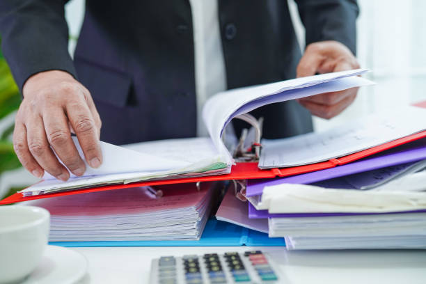 istock Businessman working and prepare paperwork report data to analysis information in file binder at office. 1413354613