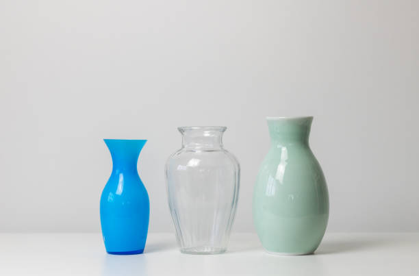 istock lose up of three different small vases on white table 1413356678