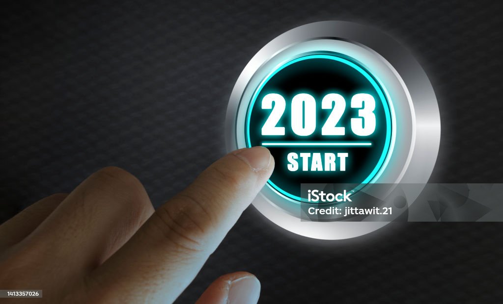 Finger about to press a car ignition button with the text 2023 start. Year two thousand and twenty three concept. Finger about to press a car ignition button with the text 2023 start. Year two thousand and twenty three concept. Composite image between a hand photography and a 3D background. 2023 Stock Photo