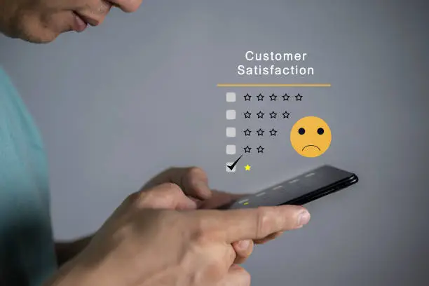 Photo of Customer Experience dissatisfied Concept, Unhappy Businessman Client with Sadness Emotion Face on smartphone screen, Bad review, bad service dislike bad quality