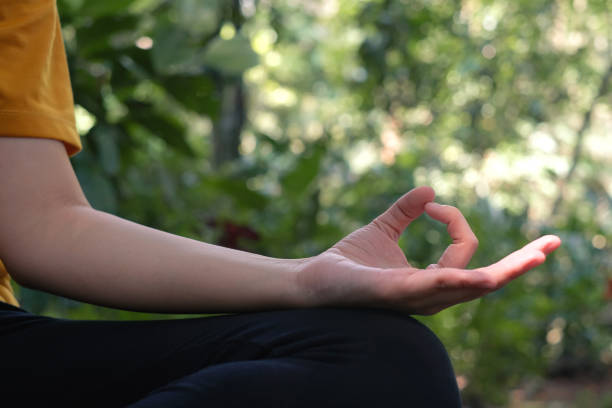 Unrecognizable Female Hands Practicing Yoga Hand Mantras - Gyan Mudra stock photo