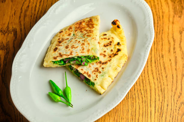 istock Flatbread stuffed with cheese and herbs. National Georgian dish 1413359687