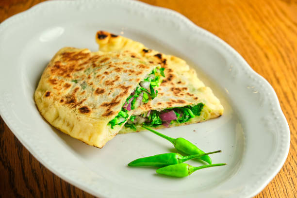 istock Flatbread stuffed with cheese and herbs. National Georgian dish 1413359708