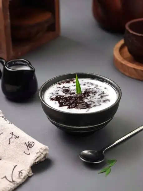 Photo of black glutinous rice porridge served on a bowl