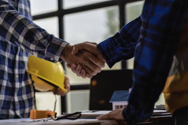 istock Engineers and construction supervisors shake hands after a consultation meeting to begin planning a new contract in the construction site office. team work concept working together and contractor 1413360806