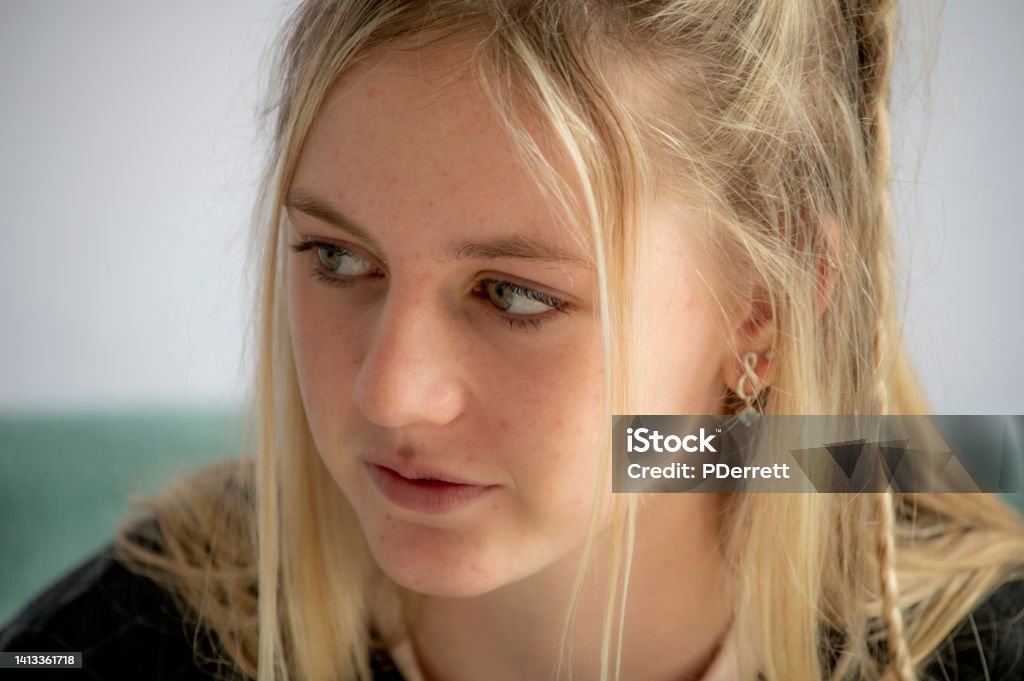 Upset young woman contemplates what has been said and what she should do. Adult Stock Photo