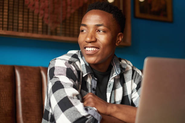 istock Working, student or creative entrepreneur with laptop thinking, planning and enjoying remote work in cafe. Inspired, motivated or ambitious freelancer brainstorming or dreaming of ideas in restaurant 1413361738