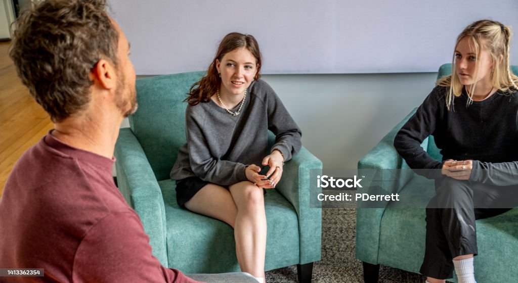 Upset young woman and her sister contemplates what has been said and what she should do. Australia Stock Photo