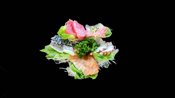 istock Salmon, tuna, saba, izumidai and octopus tentacles on black background. 1413365802